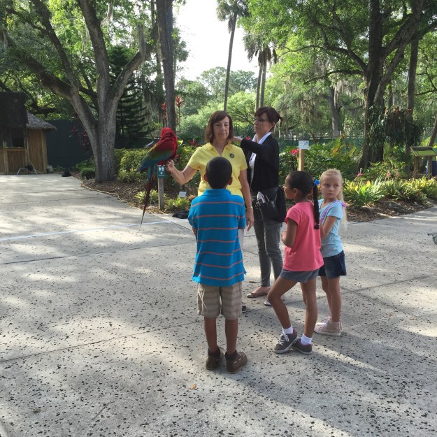 Janet, Ara's most trusted companion, listens along with the small Floridian children to Ara's tales of battle